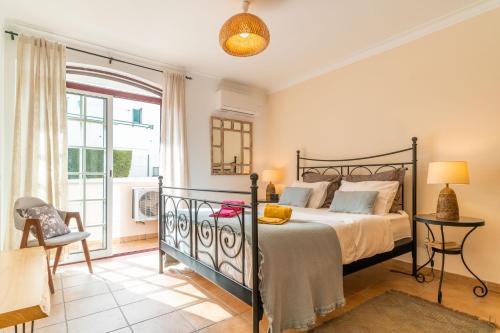 a bedroom with a bed and a balcony at LV Premier Troia in Troia
