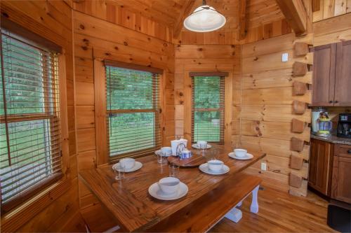 a dining room with a table in a log cabin at Blessed Way Escape in West Jefferson