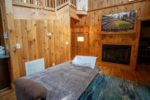 a bedroom with a bed and a tv and a fireplace at Blessed Way Escape in West Jefferson
