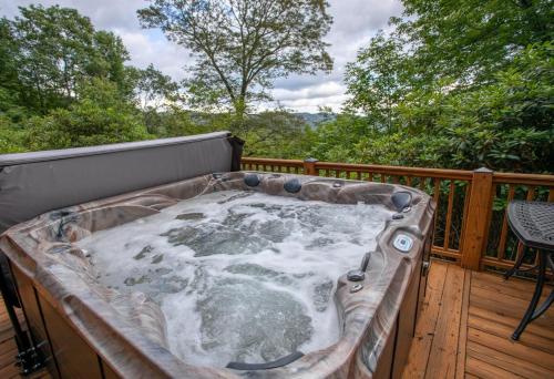 a jacuzzi tub on the deck of a house at Blue Ridge View in Blowing Rock