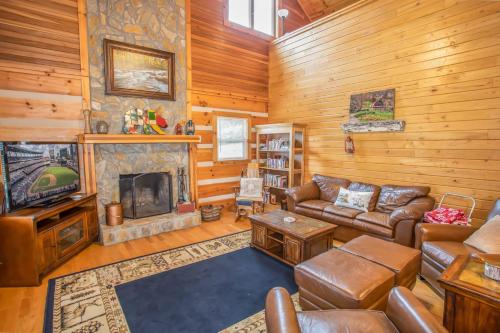 a living room with a couch and a fireplace at Boots Off Bungalow in Boone