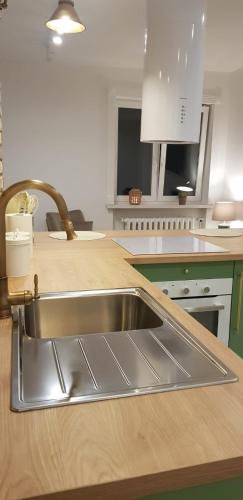 a kitchen with a stainless steel sink on a counter at Apartament The Space 2 in Drawsko Pomorskie