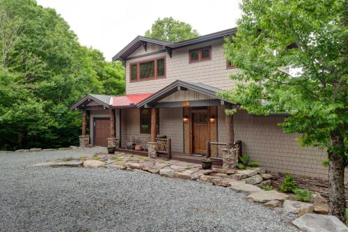 a house with a gravel driveway in front of it at Cardinal Perch in Beech Mountain