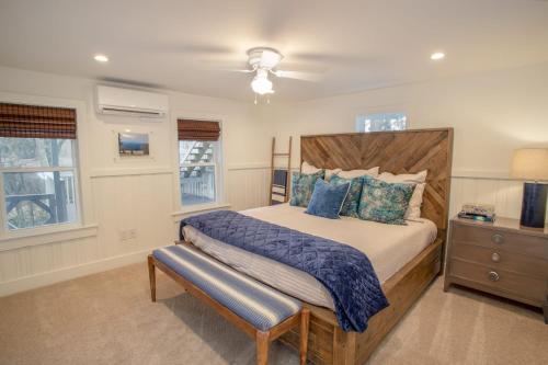 a bedroom with a large bed with a wooden headboard at Cottage Fever in Blowing Rock