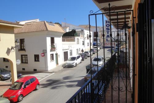 a view of a street with cars parked on the street at Hostal Cristina in Denia
