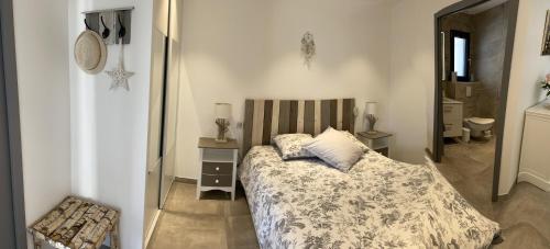 - une petite chambre avec un lit et un miroir dans l'établissement VILLA MAWENA, à Velleron