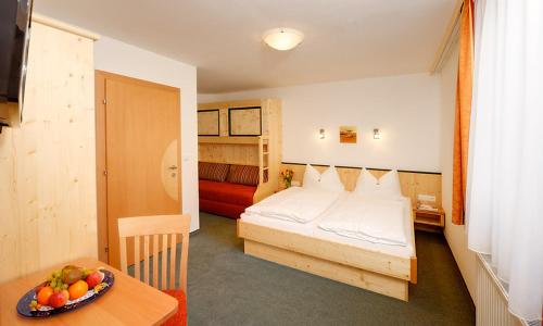 a bedroom with a bed and a bowl of fruit on a table at Werfenerhof in Werfen