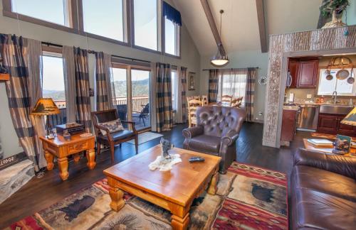 a living room with leather furniture and a table at Four Diamond Escape in Seven Devils