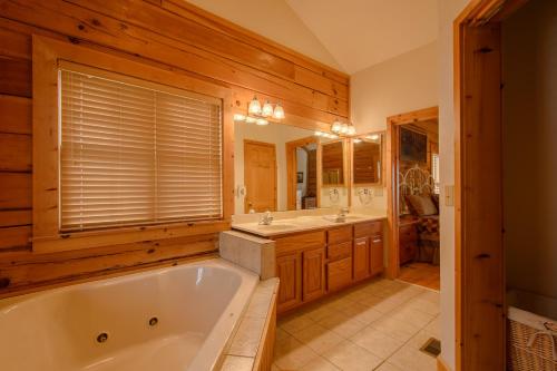 a bathroom with a tub and two sinks and a mirror at Fox Crossing in Banner Elk