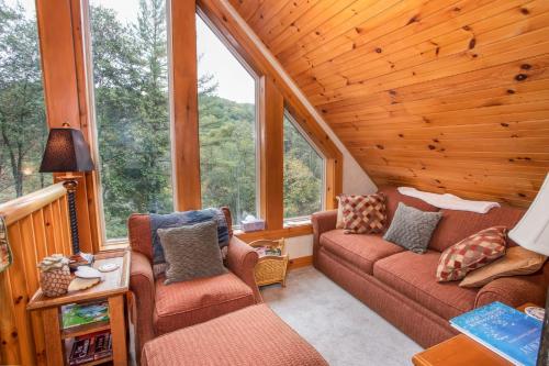 a living room with a couch and chairs in a cabin at Good River Acres in Boone