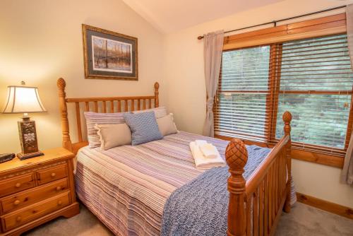 a bedroom with a bed and a window at Good River Acres in Boone
