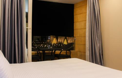 a bedroom with a bed and a dining room table at Asia Grand Museum & Pyramids view in Cairo