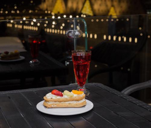 a plate with a dessert and a drink on a table at Asia Grand Museum & Pyramids view in Cairo