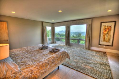 a bedroom with a bed and a large window at Heavenly Manor in Boone