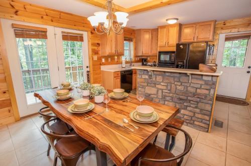 a large kitchen with a wooden table and chairs at Hidden Hawk in Seven Devils
