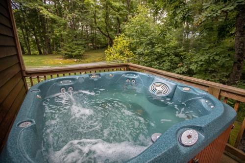 a jacuzzi tub on the back of a house at Hidden Hawk in Seven Devils
