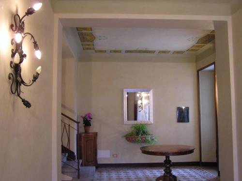 a hallway with a table and a mirror at Bed & Breakfast Villa Palma in Lovere