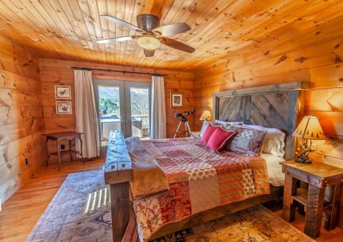 a bedroom with a bed and a ceiling fan at Hilltop Haven in Boone