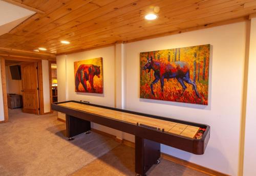 a room with two paintings of horses on the wall at Hilltop Haven in Boone