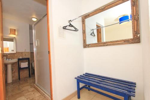 a blue bench in a room with a mirror at Hotel Real Guanajuato in Guanajuato