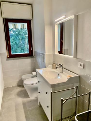 a bathroom with a sink and a toilet and a window at La casa di Carolina in Florence