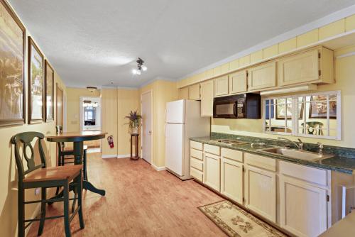 a kitchen with a table and a white refrigerator at Longview Lodge in Boone