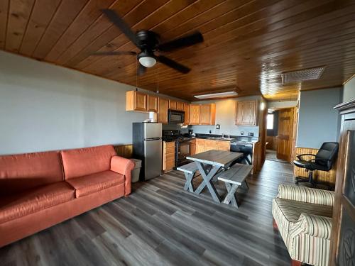 a living room with a red couch and a kitchen at Canyon Lakeview Resort in Canyon Lake