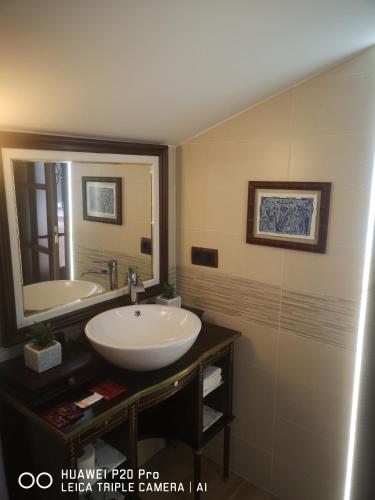 a bathroom with a sink and a mirror at Casa Tiburcio in Arenas de San Pedro