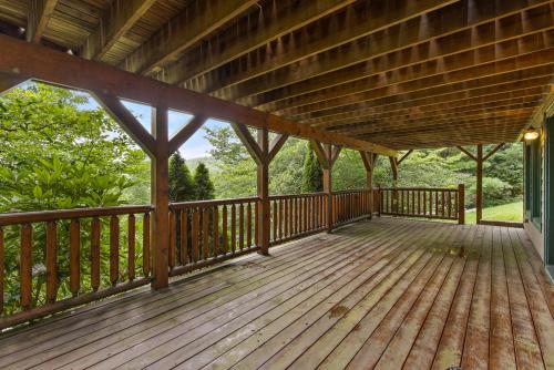 a porch of a cabin with a wooden deck at Mountain Delight in Seven Devils
