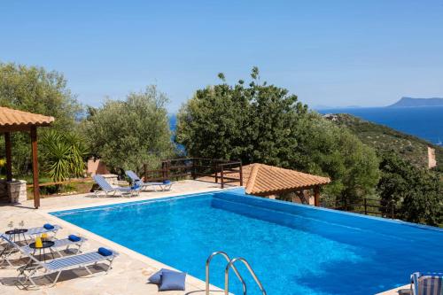 a villa with a swimming pool with a view of the ocean at Villa Thaleia in Sivota