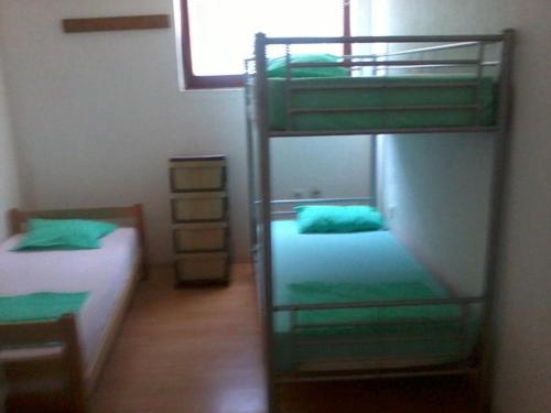 a bedroom with two bunk beds and a window at BSV Hostel in Skopje