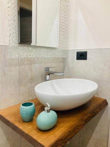 a white sink on a wooden counter in a bathroom at Cascina Manzo in Dogliani
