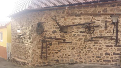 a stone wall with various weapons on it at Hotel Restaurant Platamon in Feuchtwangen