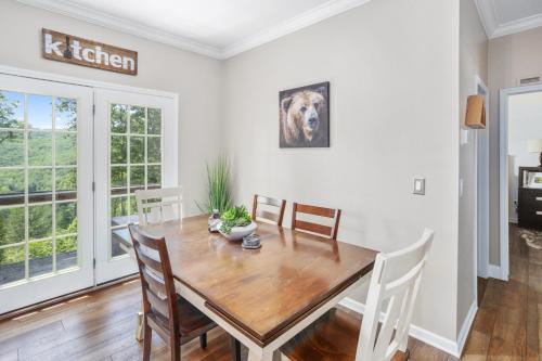 a dining room with a wooden table and chairs at Red Bear Run in Beech Mountain
