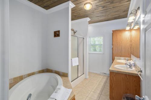 a bathroom with a tub and a sink at Red Bear Run in Beech Mountain