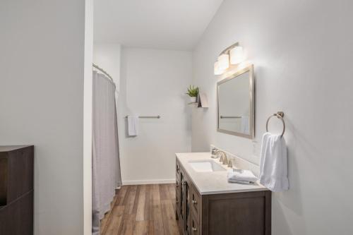 a white bathroom with a sink and a mirror at Red Bear Run in Beech Mountain