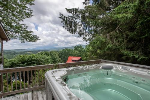 a jacuzzi tub on the deck of a house at Serendipity in Blowing Rock