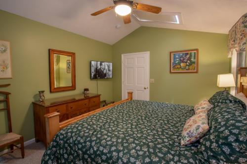a bedroom with a bed and a ceiling fan at Serendipity in Blowing Rock