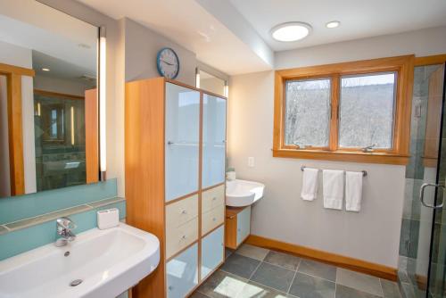 a bathroom with a sink and a mirror at Snow Dog Lodge in Beech Mountain