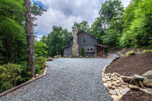 a house in the woods with a gravel driveway at Spice Ridge Retreat in Seven Devils
