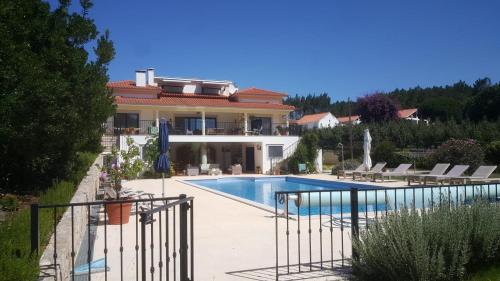 a house with a swimming pool in front of it at Quinta da Sobreira in Salir de Matos