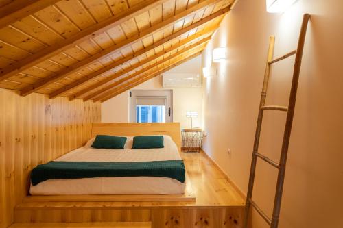 a bedroom with a bed with green and white sheets at Apartamento Férias (Apartamento Sul) in Gafanha da Encarnação