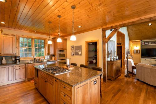 a kitchen with a stove top island in a room at The Ponderosa in Boone