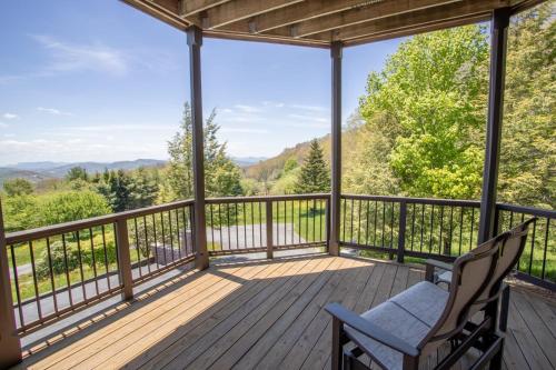 a deck with two chairs and a view of the mountains at The Retreat at Mountain Meadows in Banner Elk