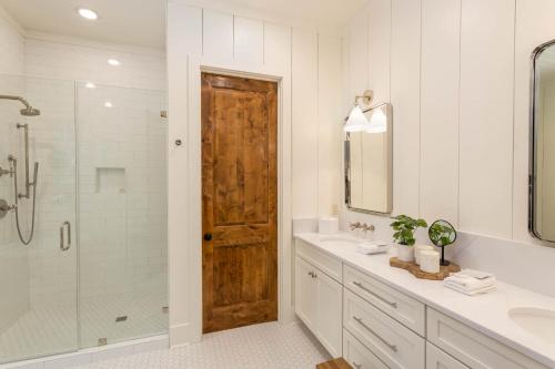 a bathroom with a shower and a wooden door at Trouvaille in Blowing Rock