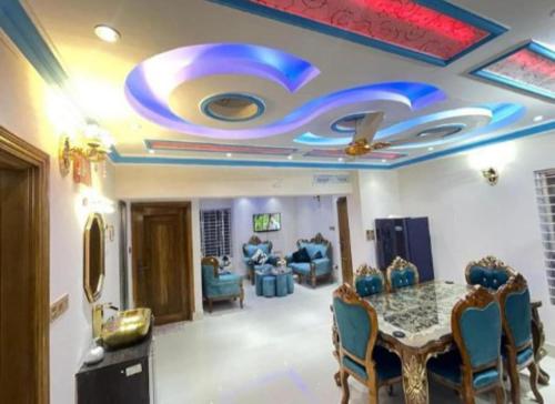 a dining room with a ceiling with a painting on it at Stunning 1-Bed Apartment in Dhaka close to airport in Dhaka