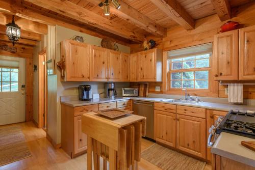 a large kitchen with wooden cabinets and a stove at Valle View in Valle Crucis