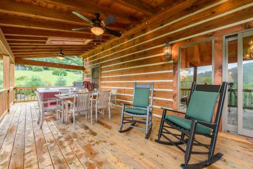 a wooden deck with chairs and a table on it at Valle View in Valle Crucis