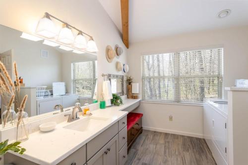 a kitchen with two sinks and a large mirror at Top Of The Hill in Seven Devils