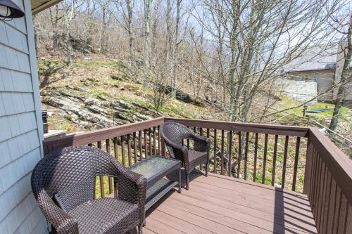 two wicker chairs sitting on a wooden balcony at Top Of The Hill in Seven Devils